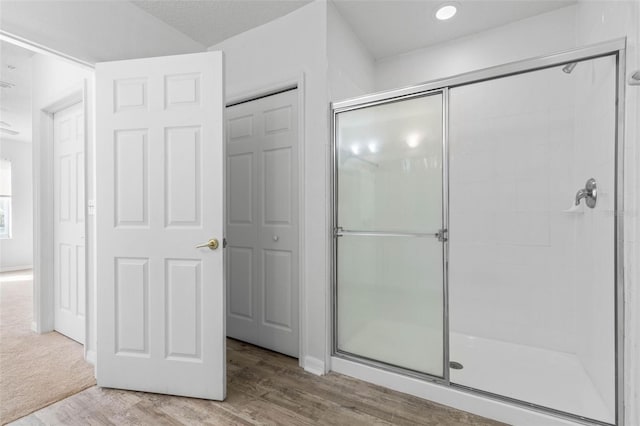 bathroom featuring wood-type flooring and walk in shower