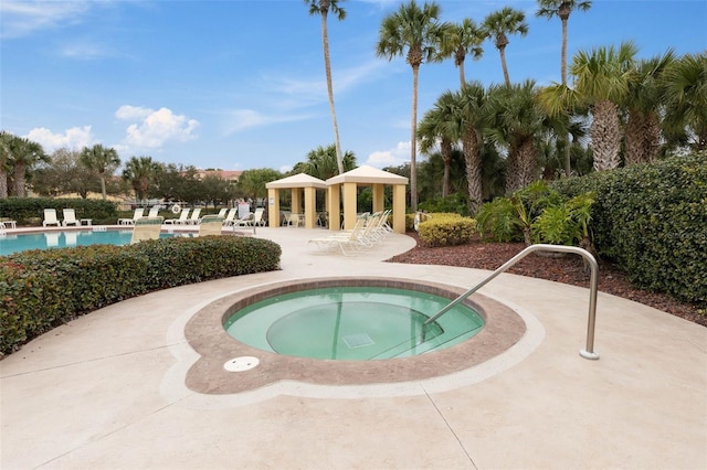 view of swimming pool with a gazebo, a community hot tub, and a patio area