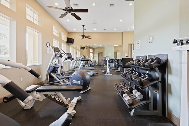 exercise room with a towering ceiling