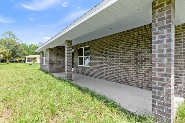 view of property exterior featuring a lawn and a patio