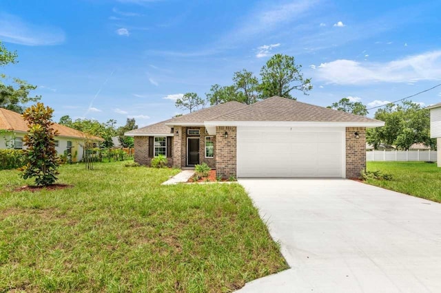 single story home featuring a garage and a front lawn