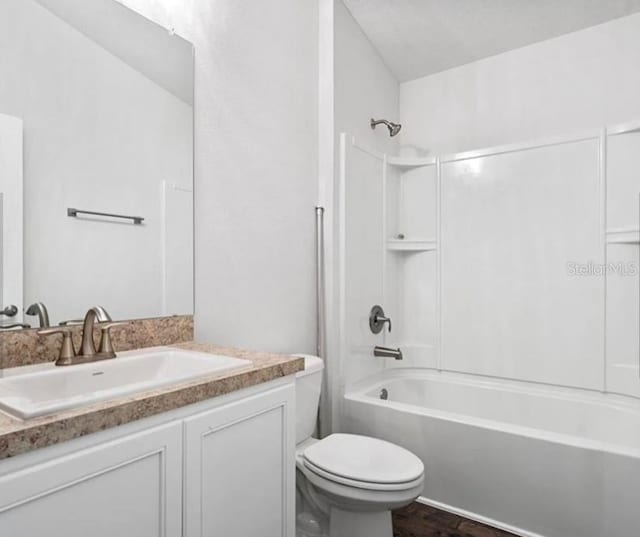 full bathroom featuring shower / bath combination, vanity, and toilet