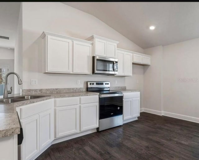 kitchen featuring dark hardwood / wood-style flooring, sink, white cabinets, and appliances with stainless steel finishes