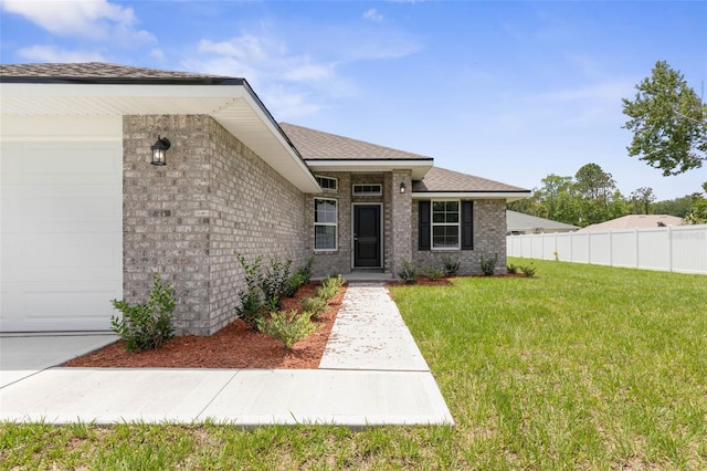 10 Zinc Pl, Palm Coast, FL 32164 - view of front of home with an attached garage, brick siding, and a shingled roof