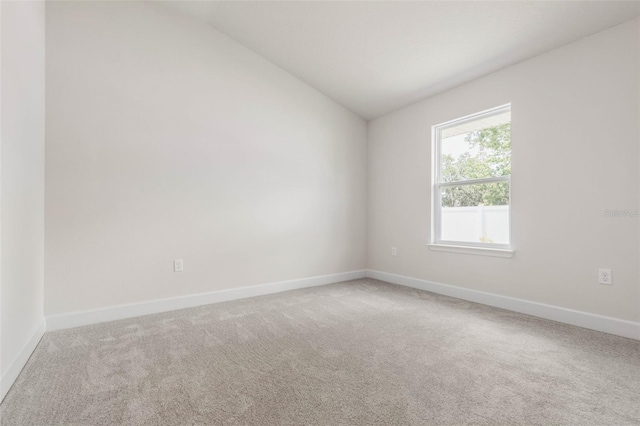 10 Zinc Pl, Palm Coast, FL 32164 - carpeted empty room featuring lofted ceiling and baseboards
