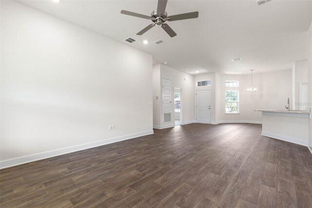 10 Zinc Pl, Palm Coast, FL 32164 - unfurnished living room with a chandelier, a ceiling fan, dark wood-style flooring, baseboards, and recessed lighting