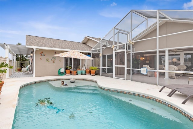 view of swimming pool featuring a patio area and a lanai