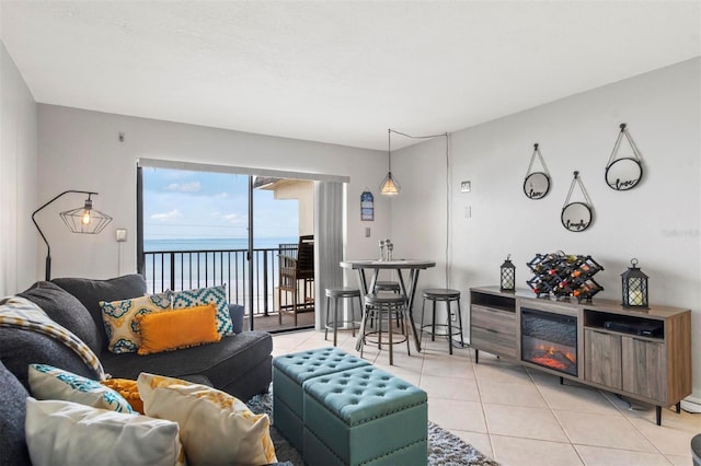 tiled living room featuring a water view