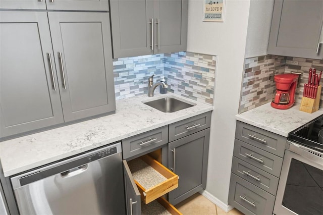 kitchen with dishwasher, gray cabinets, sink, and backsplash