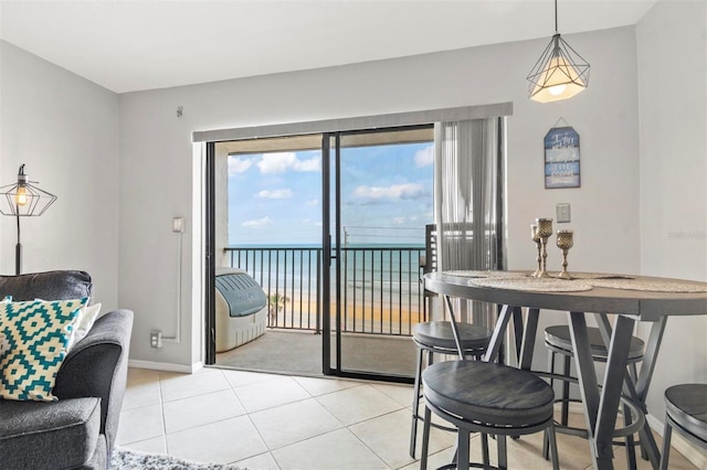 tiled dining room with a water view