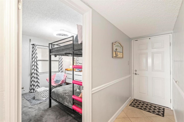 tiled bedroom with a textured ceiling