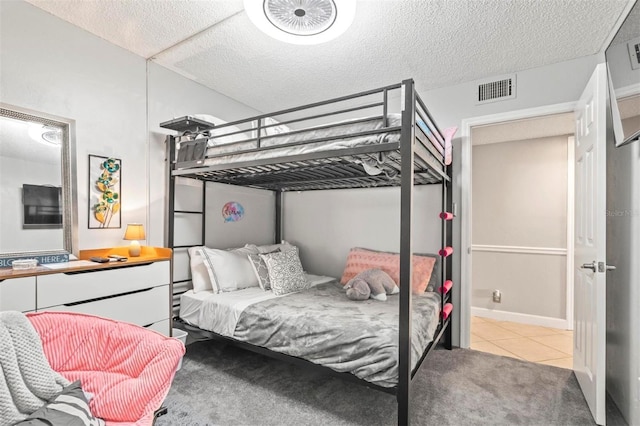 carpeted bedroom featuring a textured ceiling