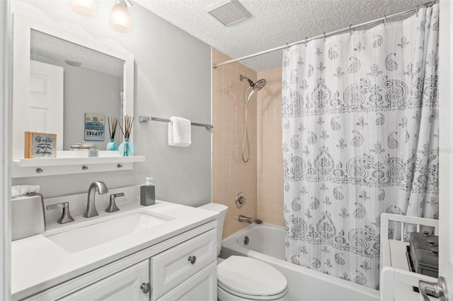 full bathroom with vanity, a textured ceiling, shower / tub combo with curtain, and toilet