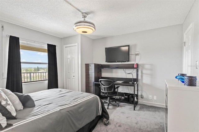 carpeted bedroom featuring a textured ceiling