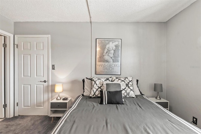 bedroom with carpet floors and a textured ceiling