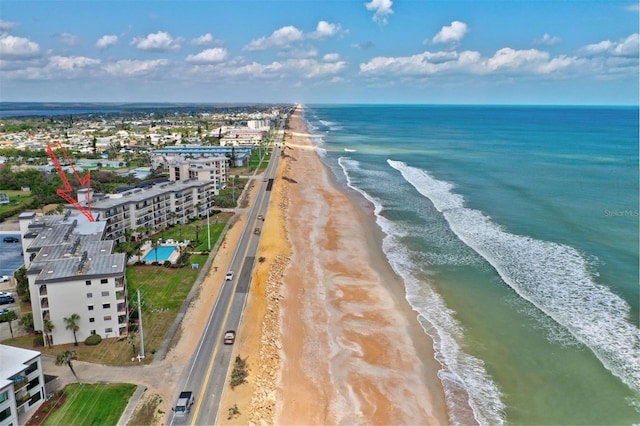 bird's eye view featuring a water view and a beach view