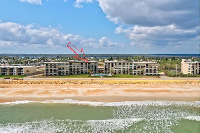 drone / aerial view featuring a water view and a view of the beach