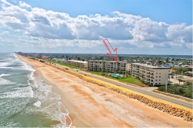 birds eye view of property featuring a view of the beach and a water view