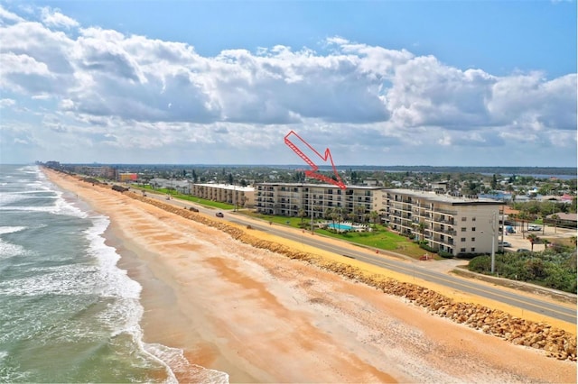 birds eye view of property with a view of the beach and a water view