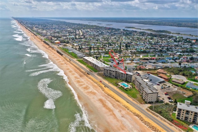 drone / aerial view featuring a beach view and a water view