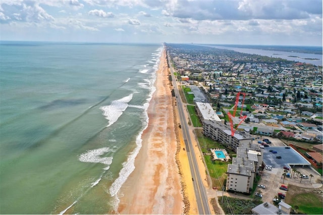 bird's eye view featuring a water view and a view of the beach