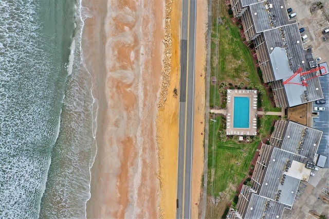 drone / aerial view with a water view and a view of the beach