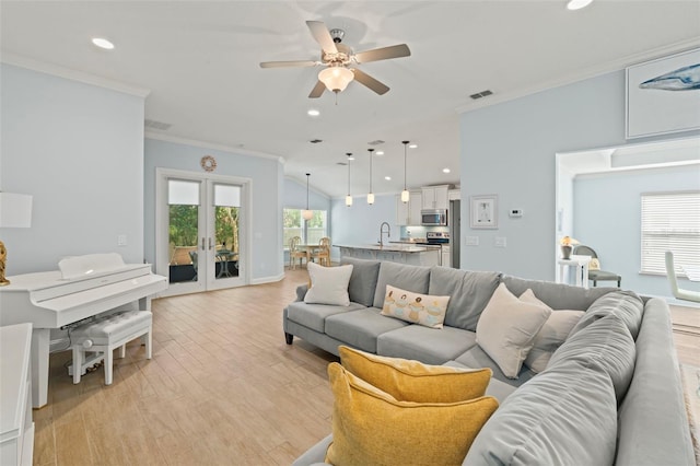 living room with recessed lighting, visible vents, light wood-style floors, french doors, and crown molding