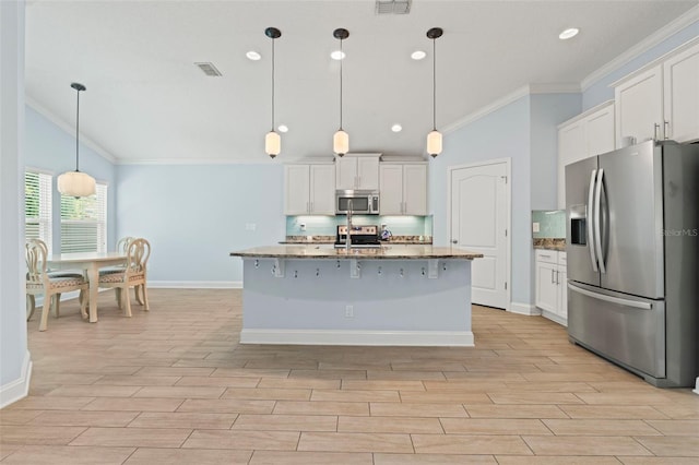 kitchen featuring stone counters, visible vents, appliances with stainless steel finishes, wood tiled floor, and crown molding