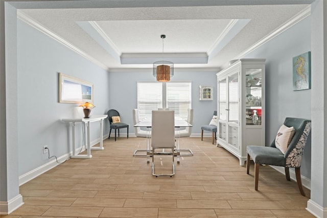 sitting room with ornamental molding, wood tiled floor, a raised ceiling, and a textured ceiling