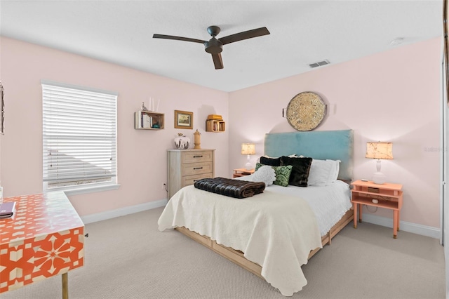 bedroom featuring a ceiling fan, visible vents, baseboards, and carpet flooring