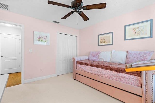 bedroom featuring carpet, a closet, visible vents, and baseboards