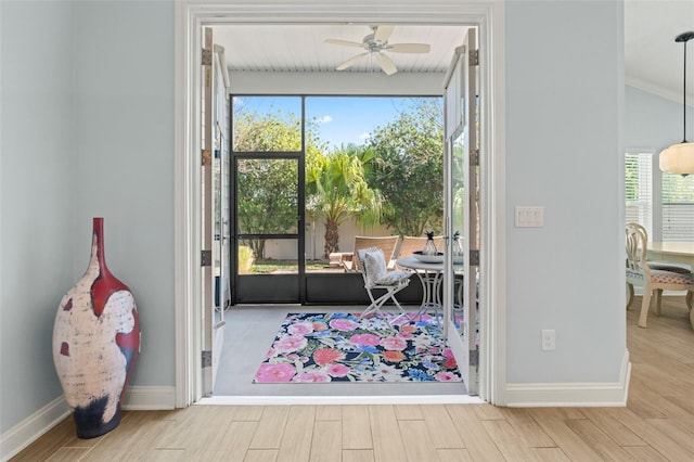 entryway with baseboards, a ceiling fan, and wood finished floors