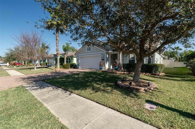 single story home featuring board and batten siding, a garage, driveway, and a front lawn