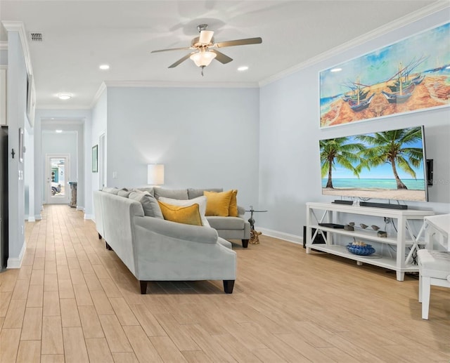 living area with ornamental molding, baseboards, visible vents, and light wood finished floors