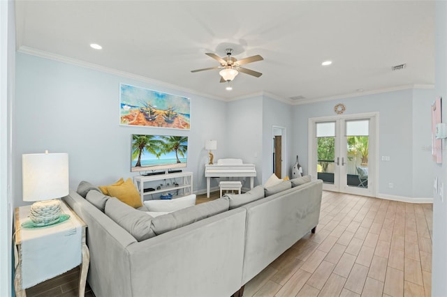 living room with light wood finished floors, french doors, ornamental molding, and baseboards