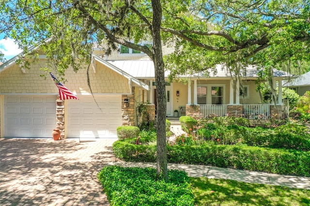 craftsman-style house with a porch and a garage