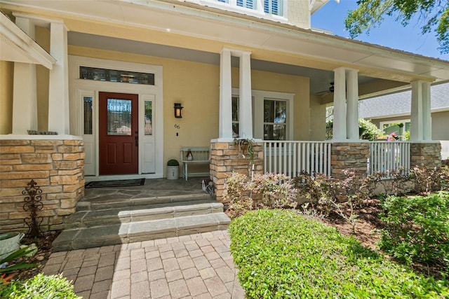 doorway to property with a porch and ceiling fan