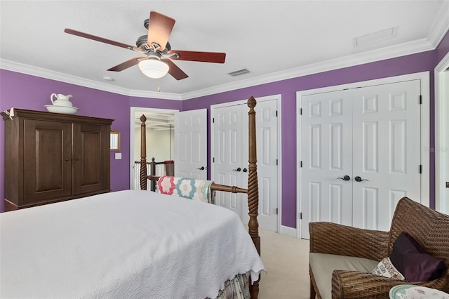 carpeted bedroom featuring ceiling fan, crown molding, and two closets