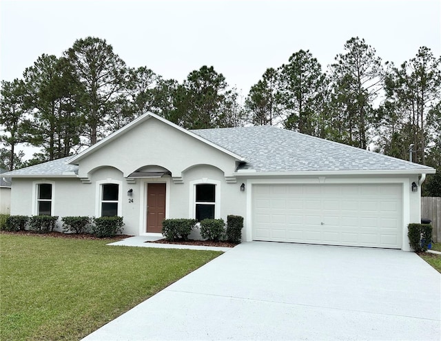 single story home with a front yard and a garage