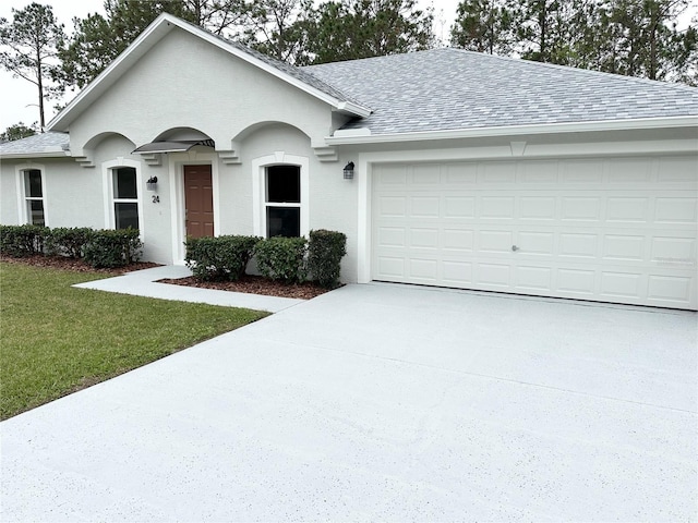 ranch-style home with a front yard and a garage