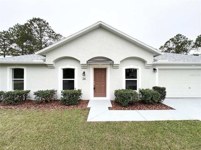 single story home with a front yard and a garage