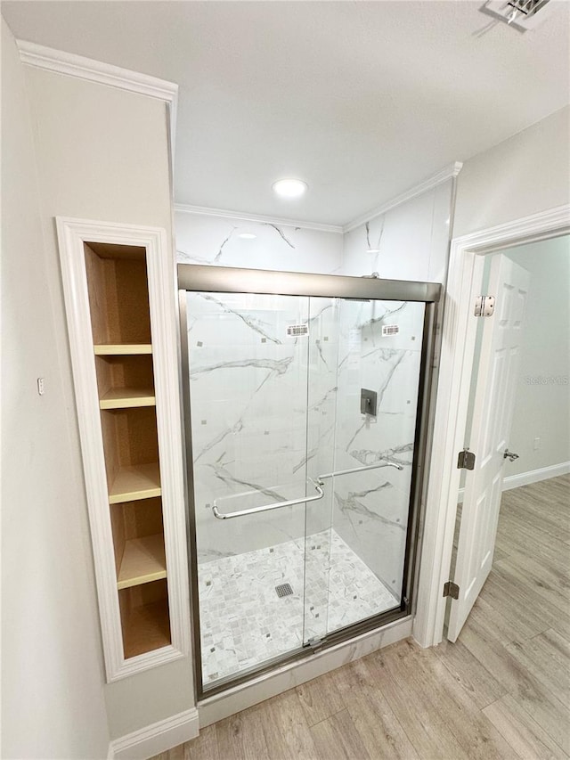 bathroom featuring hardwood / wood-style flooring and walk in shower