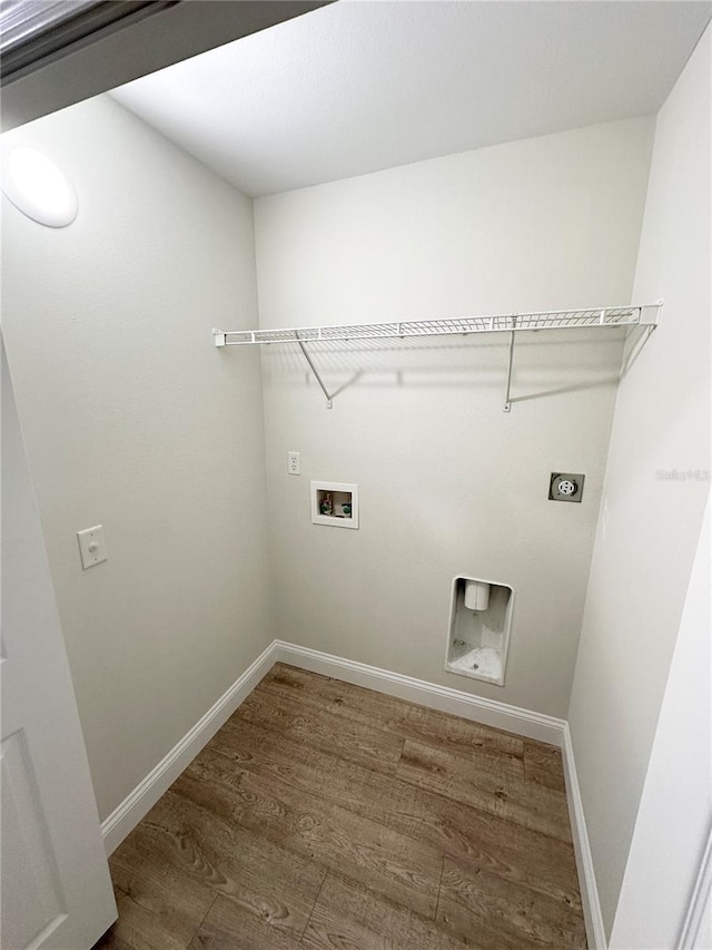 laundry room with washer hookup, dark wood-type flooring, and electric dryer hookup