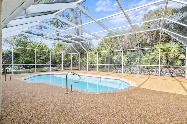 view of swimming pool with a patio and glass enclosure