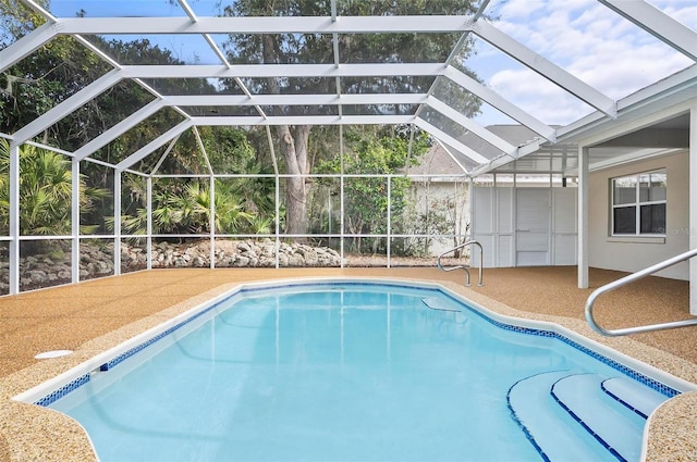 view of pool with a lanai and a patio