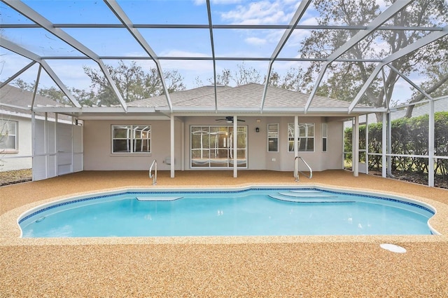 view of pool featuring glass enclosure and a patio