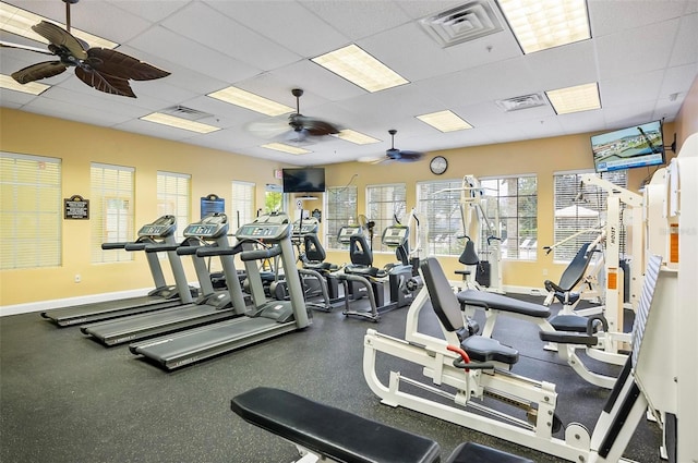 workout area featuring ceiling fan and a drop ceiling