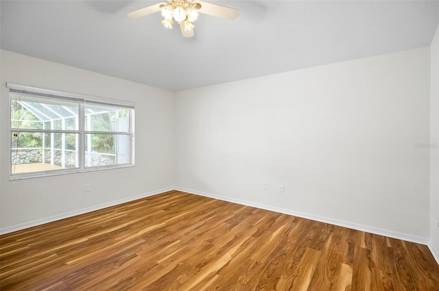 spare room with hardwood / wood-style floors and ceiling fan