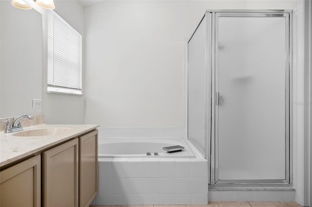 bathroom featuring tile patterned floors, vanity, and separate shower and tub