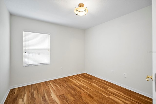 spare room with hardwood / wood-style flooring